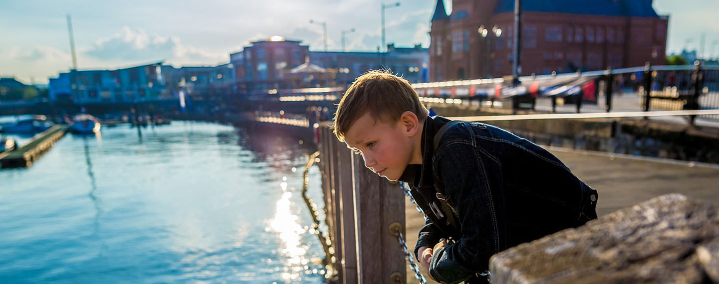 A child pondering over the River